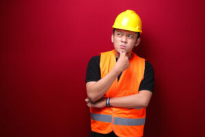 Thinking Young asian man worker is seriously think gesture on red background